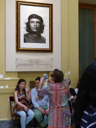 A visitor takes a picture of a picture of Che Guevara