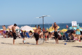 Typical beach scene - showers are set up at regular intervals along the beach